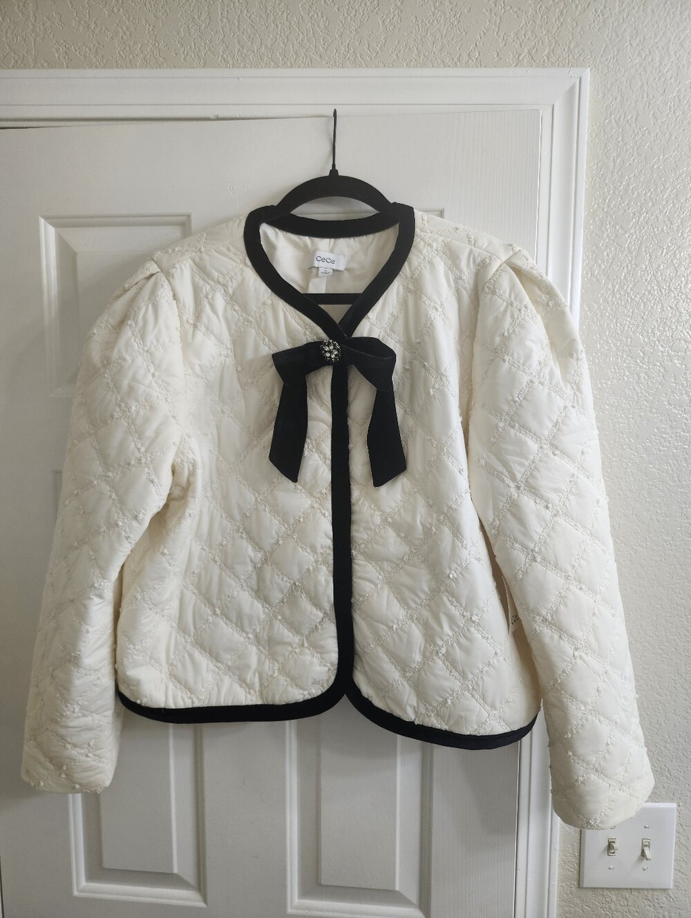 CeCe Cream Quilted Jacket with Black Velvet Bow and Trim